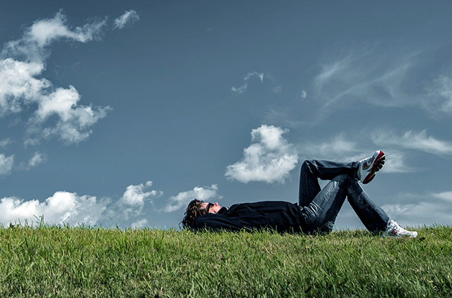 man lying down on the grass