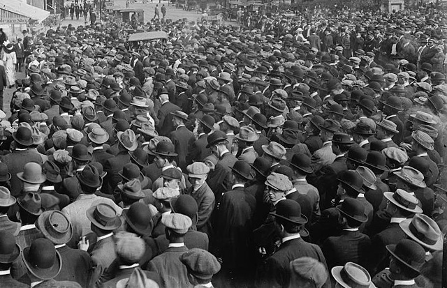 A large crowd waiting to enter a baseball game