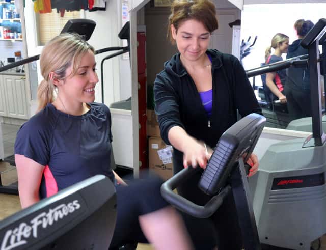 personal trainer helping a client