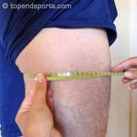 Upper thigh girth measurement technique showing tape placement 1cm below gluteal fold