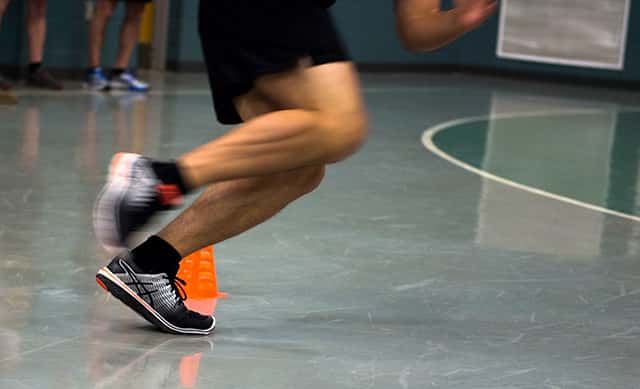Athlete turning around cone during agility test