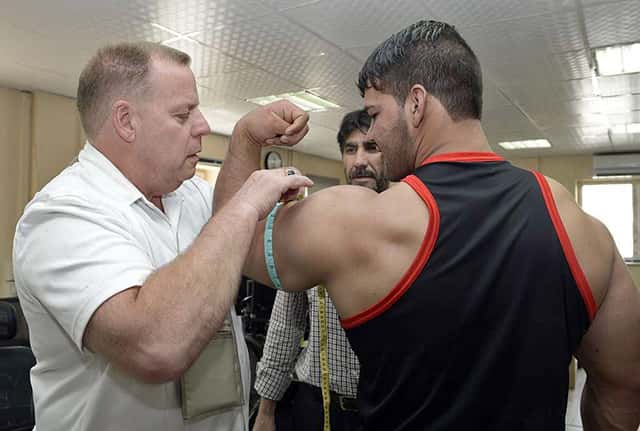 Measuring flexed biceps girth with tape measure