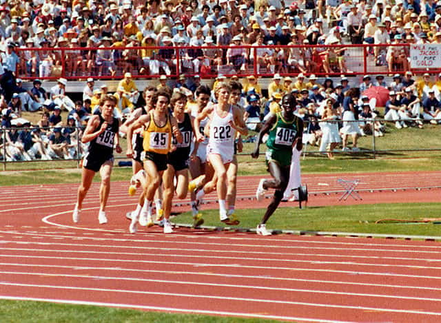 A Kenyan athlete leads the pack in the final of the men's 1500m at the 1982 COmmonwealth Games (image: Queensland State Archives)