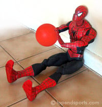 Athlete performing seated medicine ball throw test against wall