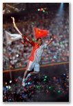 Chinese gymnast Li Ling, who won three gold, two silver and one bronze medal at the 1984 Summer Games in Los Angeles, carries the Olympic Torch while descending from rafters after running around the upper rim of the Bird's Nest National Stadium during the Opening Ceremony of the Summer Olympic Games in Beijing on Aug. 8, 2008.This photo is by Tim Hipps, FMWRC Public Affairs. This image is a work of a U.S. Army soldier or employee, taken or made during the course of the person's official duties. As a work of the U.S. federal government, the image is in the public domain.