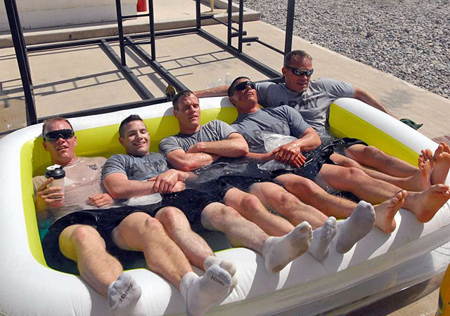 Army soldiers cool down in an ice bath