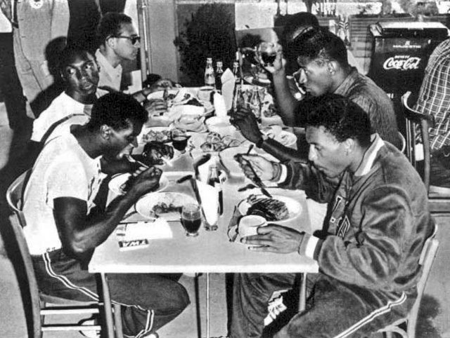 American athletes enjoying a meal at a village dining room
