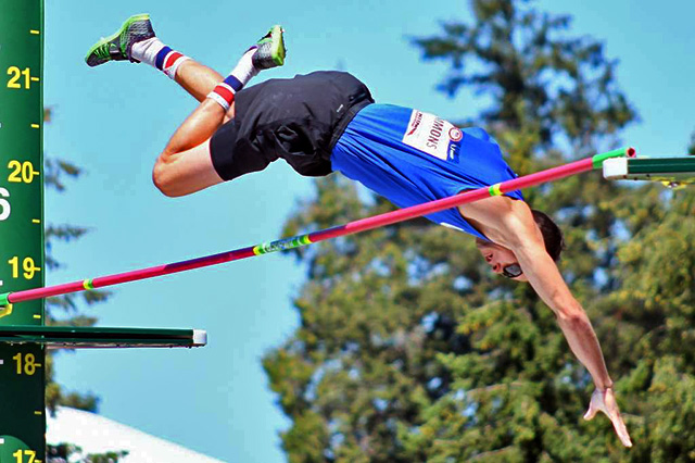 an athlete clears the bar in the pole vault