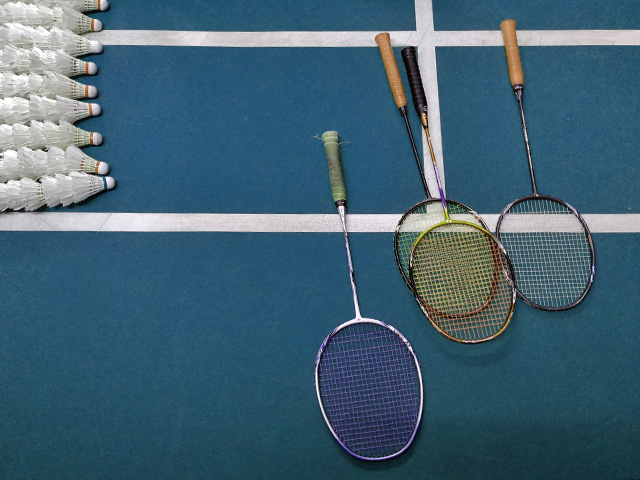 badminton racket and shuttlecocks on a court