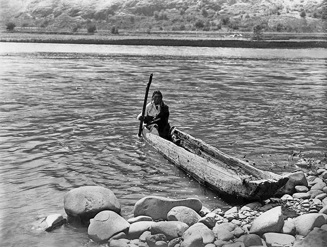 native American in a canoe