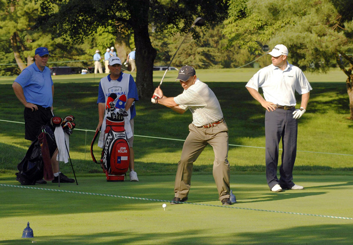 golfer driving the ball off a tee