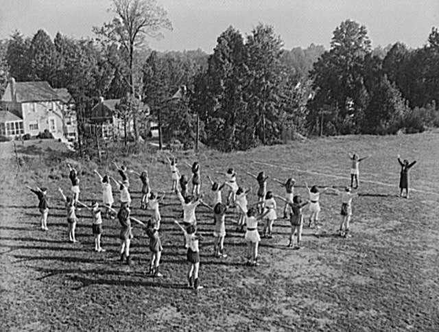 girls performing calistrnics outdoors in 1942