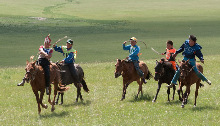 boys racing horses in Mongolia