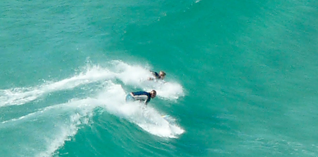two surfers battling
