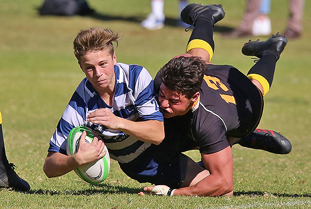 young rugby player gteting tackled