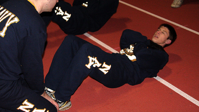 Navy recruits doing the sit up assessment



