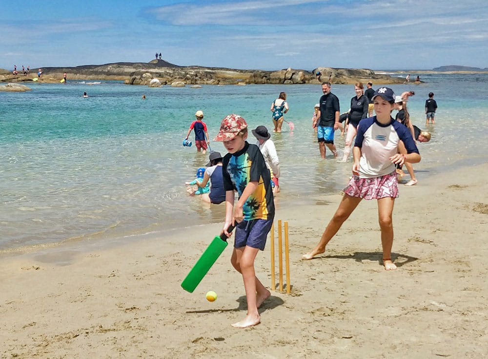 Playing beach cricket